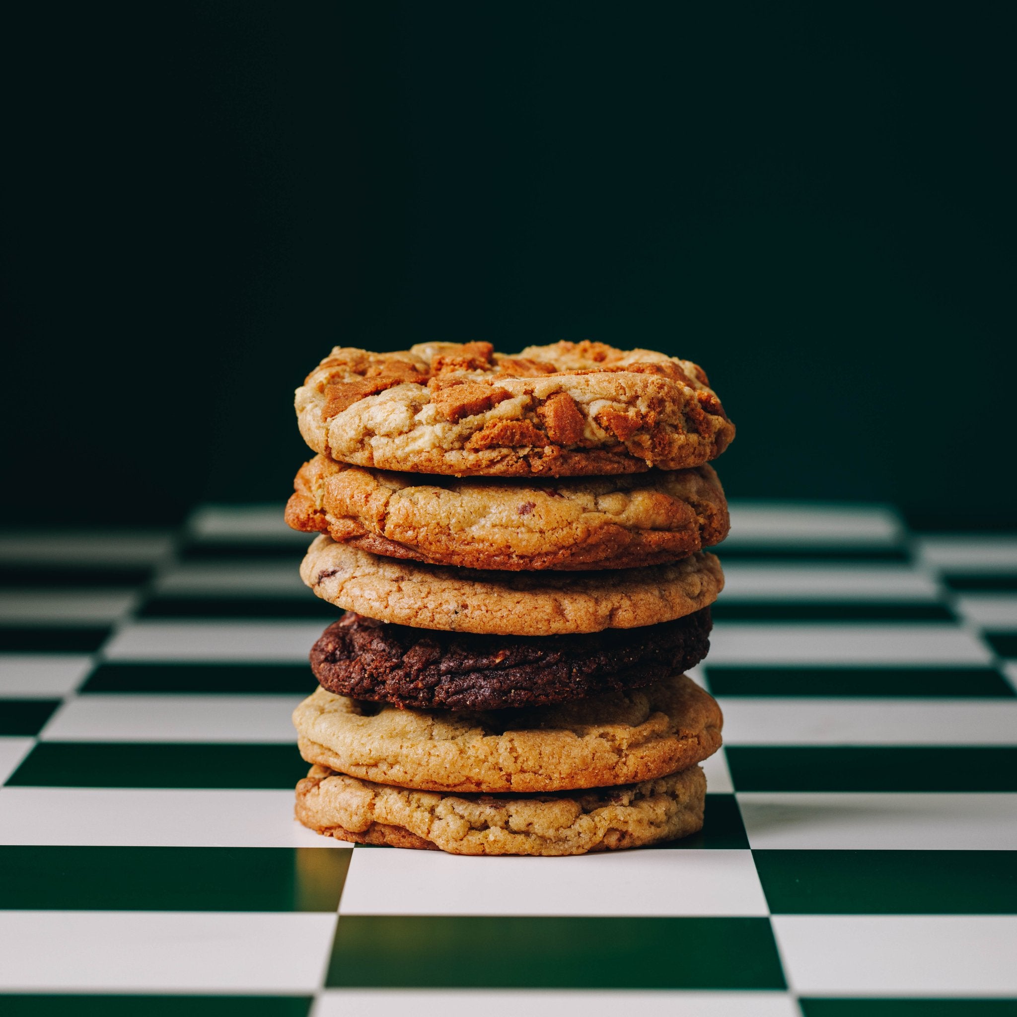 Stack of Variety cookies, checkered green and white bench